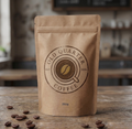 Brown paper coffee bag with 'Old Quarter Coffee' branding on a wooden table with scattered coffee beans.